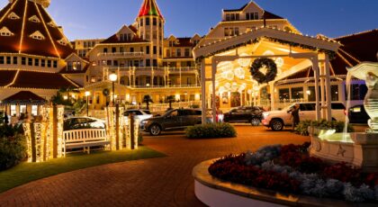 Stunning evening photo of a beautifully lit hotel with festive decorations and vibrant lights.