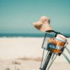 A vintage bicycle with a sun hat and towel at Coronado Beach, perfect summer vibes.