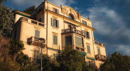 A grand mansion in Como, Italy with stunning architectural details, captured at sunset.