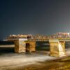 Stunning night view of the Galle Face pier in Colombo with tourists enjoying the sea breeze.