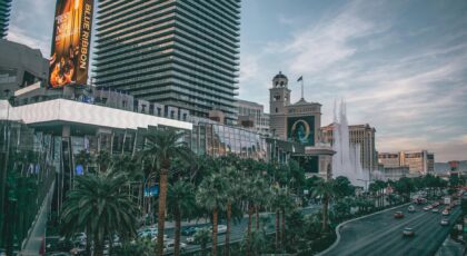 Vibrant view of Las Vegas's iconic skyline and busy boulevard with modern buildings and neon lights.