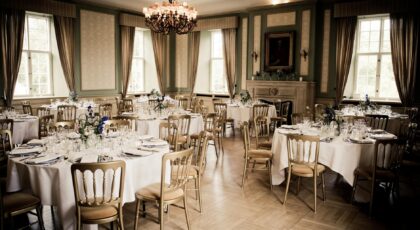Luxurious dining room with elegant table setting and chandelier, ideal for fine dining events.