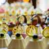 A close-up of beautifully presented desserts topped with dried lemon slices, showcasing exquisite catering.