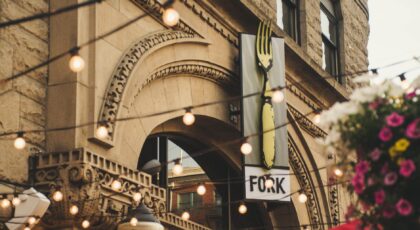 Elegant archway of Fork restaurant in Boise, Idaho with lights and flowers.
