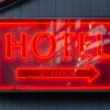 Close-up of a neon hotel sign indicating the 3rd floor, vibrant in red.
