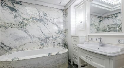 Elegant bathroom with marble walls and modern fixtures creating a luxurious at-home experience.