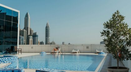 Relaxation at a rooftop pool with stunning Dubai skyline, capturing modern urban living.
