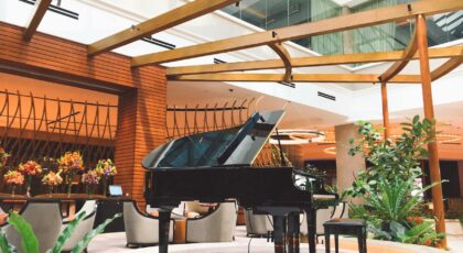 An elegant hotel lobby in Manila featuring a grand piano and modern interior design elements.