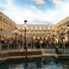 A bustling Venetian-themed shopping area with canals and classic architecture in Las Vegas.