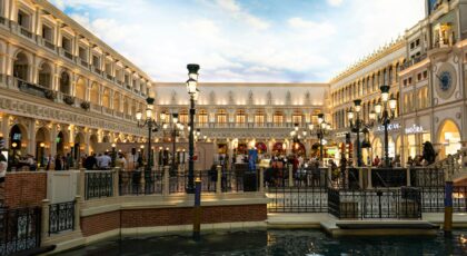 A bustling Venetian-themed shopping area with canals and classic architecture in Las Vegas.
