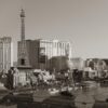 Black and white photo of Las Vegas Strip featuring the Eiffel Tower replica and surrounding hotels.