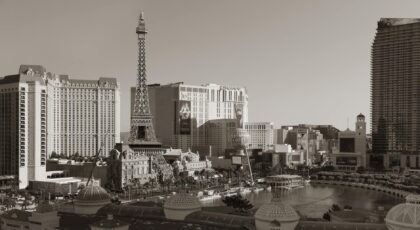 Black and white photo of Las Vegas Strip featuring the Eiffel Tower replica and surrounding hotels.