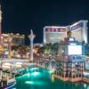A stunning night view of Las Vegas Strip featuring illuminated landmarks and vibrant reflections.