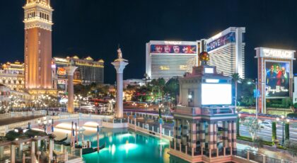 A stunning night view of Las Vegas Strip featuring illuminated landmarks and vibrant reflections.