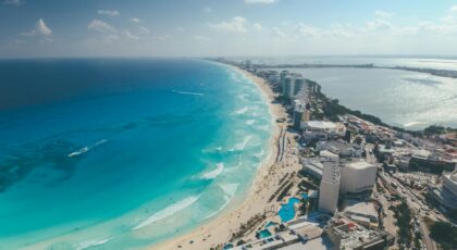 Breathtaking aerial photograph capturing Cancun's clear blue waters and vibrant cityscape.