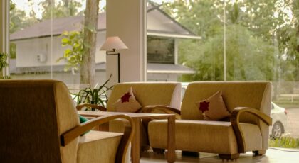 Elegant lobby with comfortable sofas, large windows, and natural light enhancing the indoor ambiance.